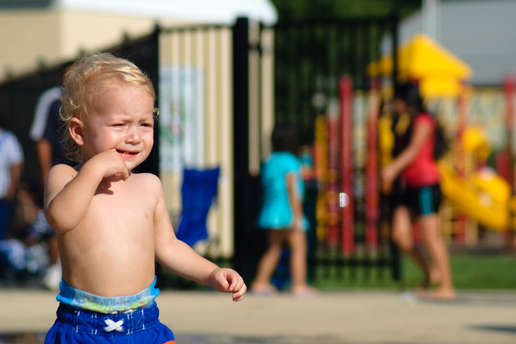 Enjoying the spraypark considerably less than his siblings