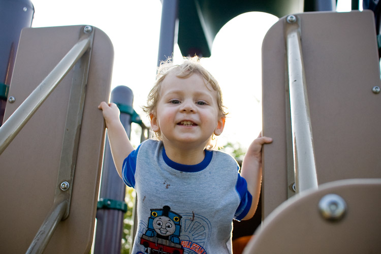 Not letting a runny nose and chocolate ice cream-stained shirt ruin his fun at the playground