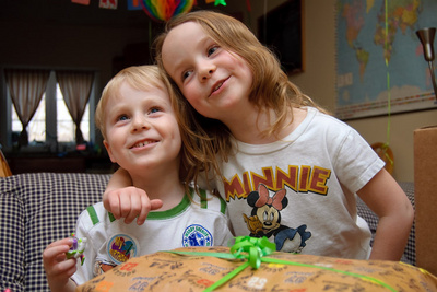 It's hard to tell who is the prouder of the two--the birthday boy or his big sister