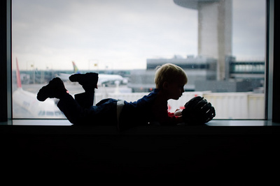 Ivan patiently awaits our plane with his new baseball glove (and companion)