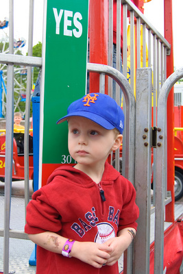 Big enough to ride most of the carnival rides now, Ivan wraps his excitement in a thick layer of seriousness