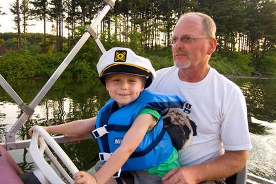 Honorary captain Ivan poses for a picture while the skipper keeps an eye on the water