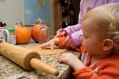 Nikola gets a hand with the Halloween cookies from his designated helper, Veronika