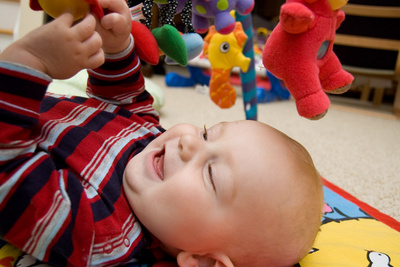 Happily lost in his activity mat world (bonus points for naming the Teletubby above him!)