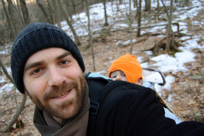 Father and son taking to the woods for a hike on a crisp February afternoon