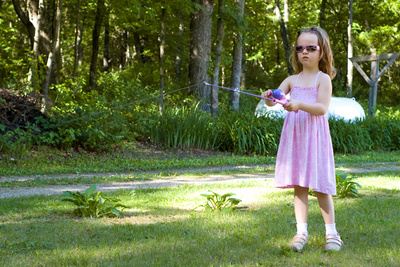 Getting a few practice casts in on land in preparation for her first fishing trip
