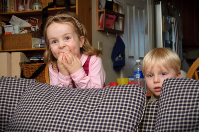 Watching a particularly tense part of 'Cars' from their safe haven behind the sofa