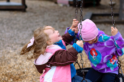 Reunited friends, delirious on the swing