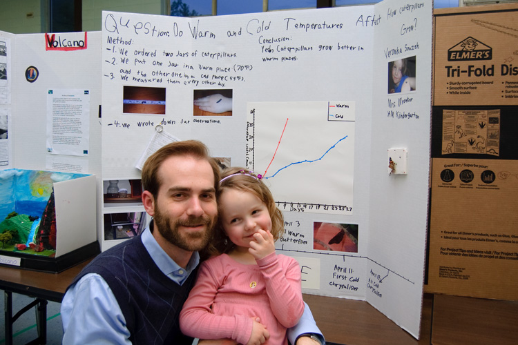 It's hard to tell who is prouder of Veronika's science fair project