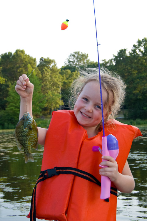 Proud of her sunfish, the biggest catch of the day
