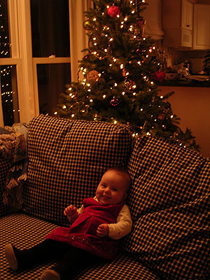 Smiling in front of the tree on Christmas Eve