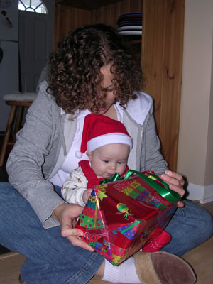 Determinedly opening a present from Mama and Papa