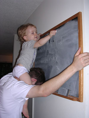 Writing on the board, with a little help from Papa
